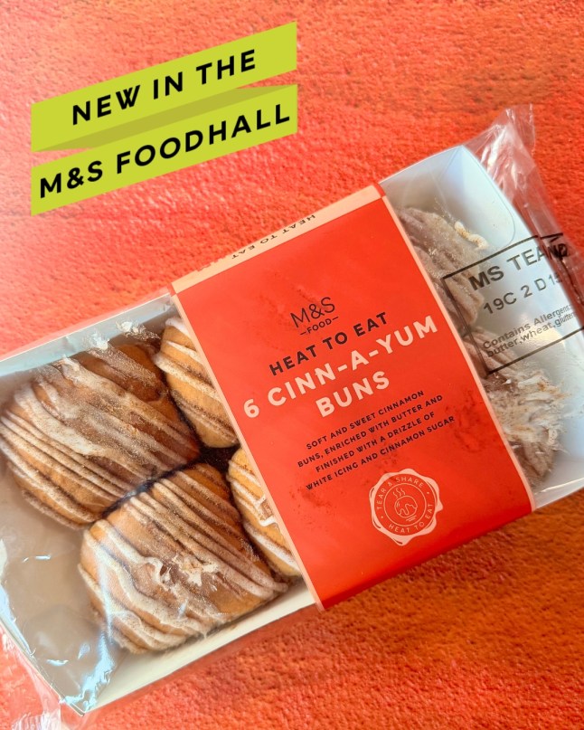 An M&S ad for new Cinn-A-Yum Buns, with a pack of them on a red table