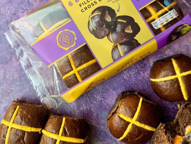 A packet of M&S new Dippy Egg Hot Cross Buns with a purple background